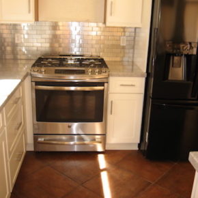 kitchen with chrome oven and backsplash.