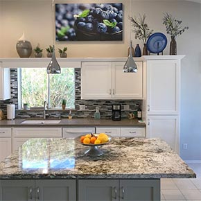 lovely kitchen with marble counter tops.